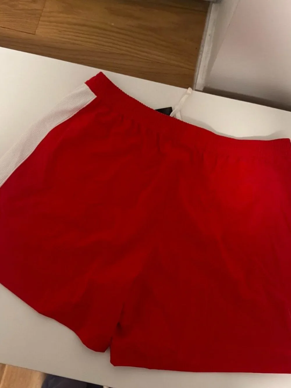 Nike red shorts with white side panels